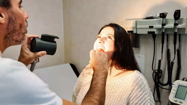 Medical professional examining a patient for oral cancer